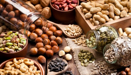 Assortment of nuts on rustic wood table.