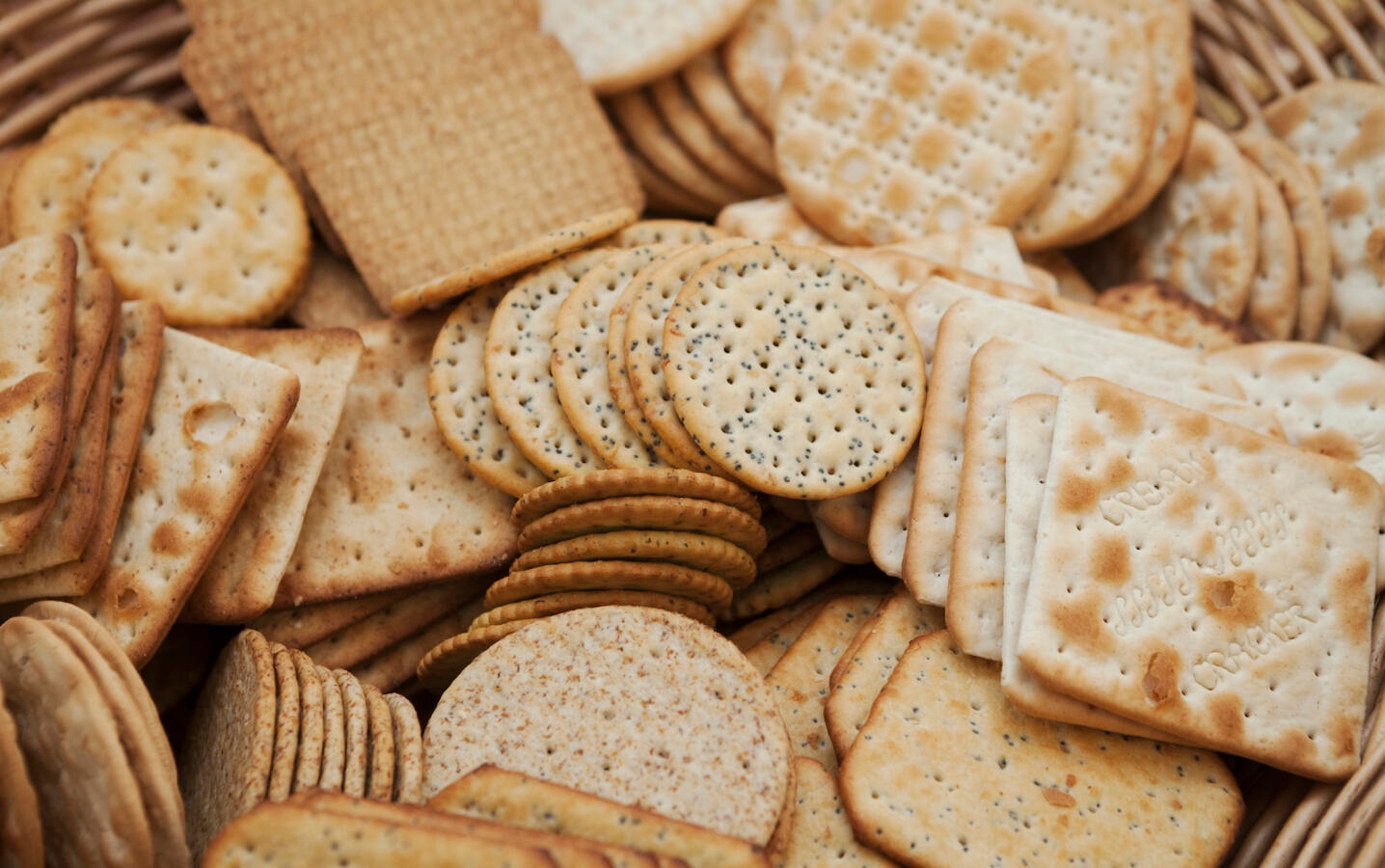 Close up of a large selection of cream crackers.
