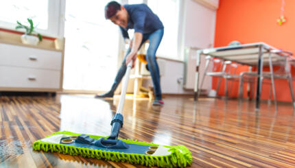 Adult Woman Cleaning Floor in Her Apartment.