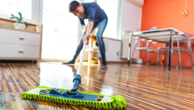 Adult Woman Cleaning Floor in Her Apartment.