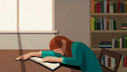 Tired college student sleeping on book at sunny table in library