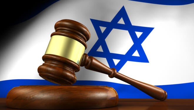 Israel law, legal system and justice concept with a 3d render of a gavel on a wooden desktop and the Israeli flag on background.