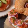 Bagel sandwich with salmon, cream cheese, cucumber, and onions flagel flat bagel