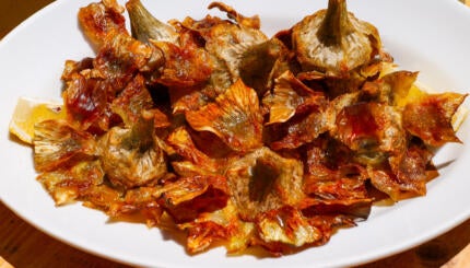Rome, Italy - The traditional Italian cuisine is based on the Mediterranean diet, composed of natural and fresh products, including fruit, vegetables and cereals. In the photo: A typical dish of artichokes, coked according to the recipe of the Jewish Quarter of Rome (Roman Ghetto). Image in HD format.