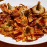 Rome, Italy - The traditional Italian cuisine is based on the Mediterranean diet, composed of natural and fresh products, including fruit, vegetables and cereals. In the photo: A typical dish of artichokes, coked according to the recipe of the Jewish Quarter of Rome (Roman Ghetto). Image in HD format.