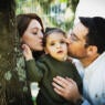 Photo of a Jewish couple kissing their child.