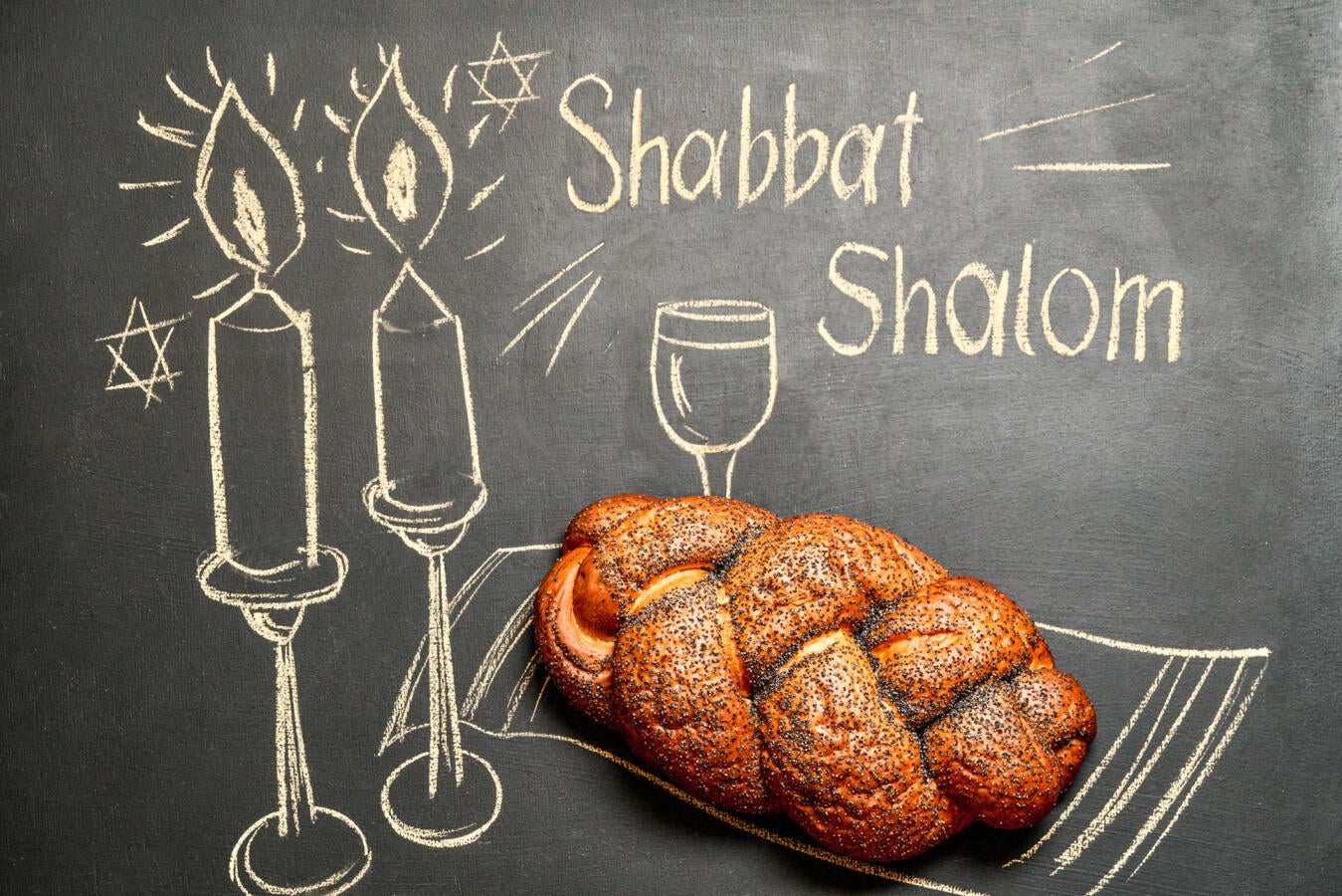 chalkboard that says "shabbat shalom" with challah
