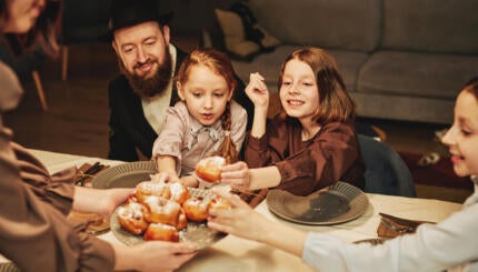 Woman serving pastry to her family.