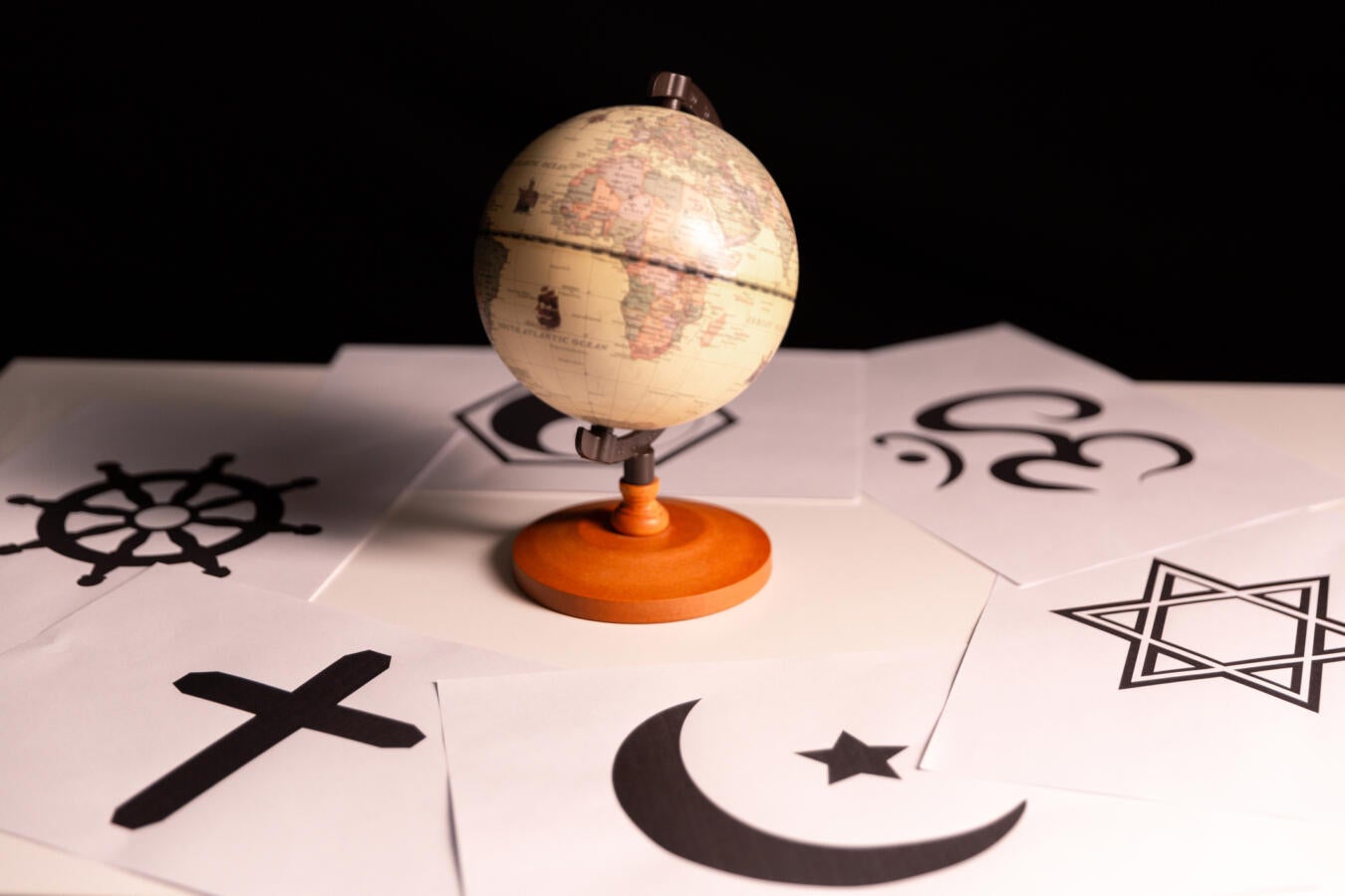 image of a globe surrounding by symbols of different faith traditions