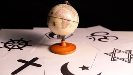 image of a globe surrounding by symbols of different faith traditions
