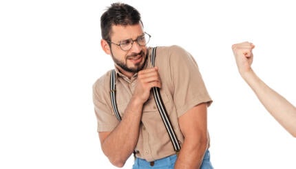 Man cringing in front of someone else's fist.
