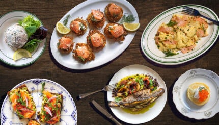 Plates of fish dishes on a table.